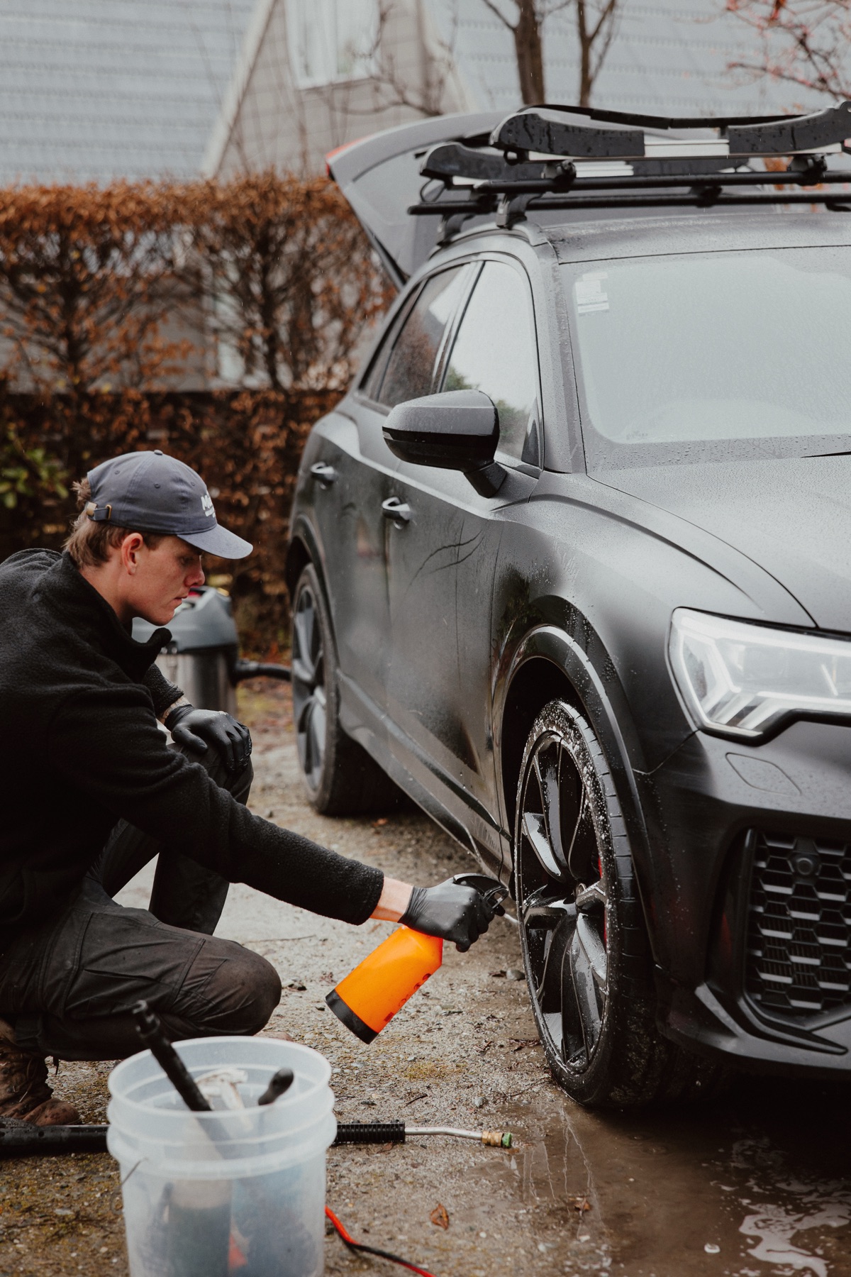 Process shot - working through the wash stages on a black Audi