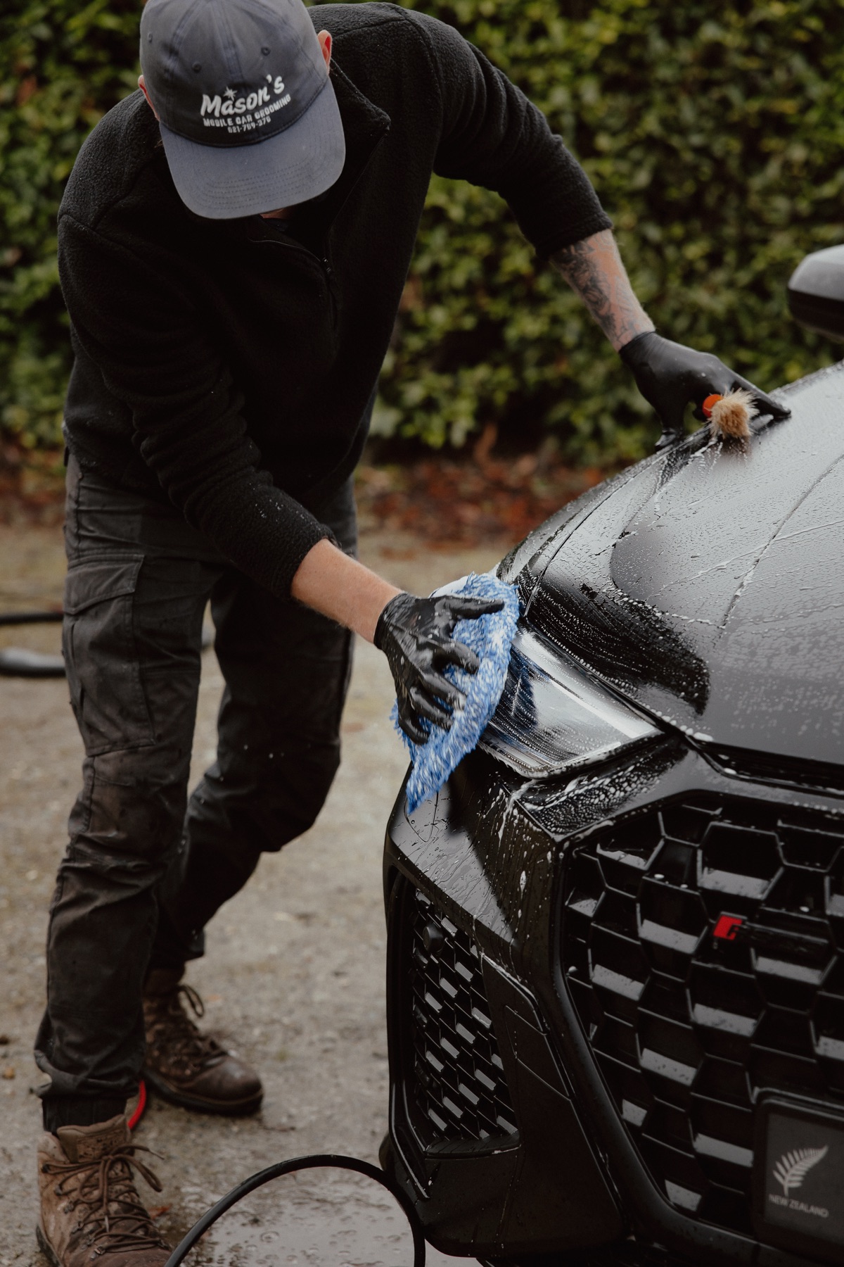 Close-up detailing work on matte black Audi paintwork