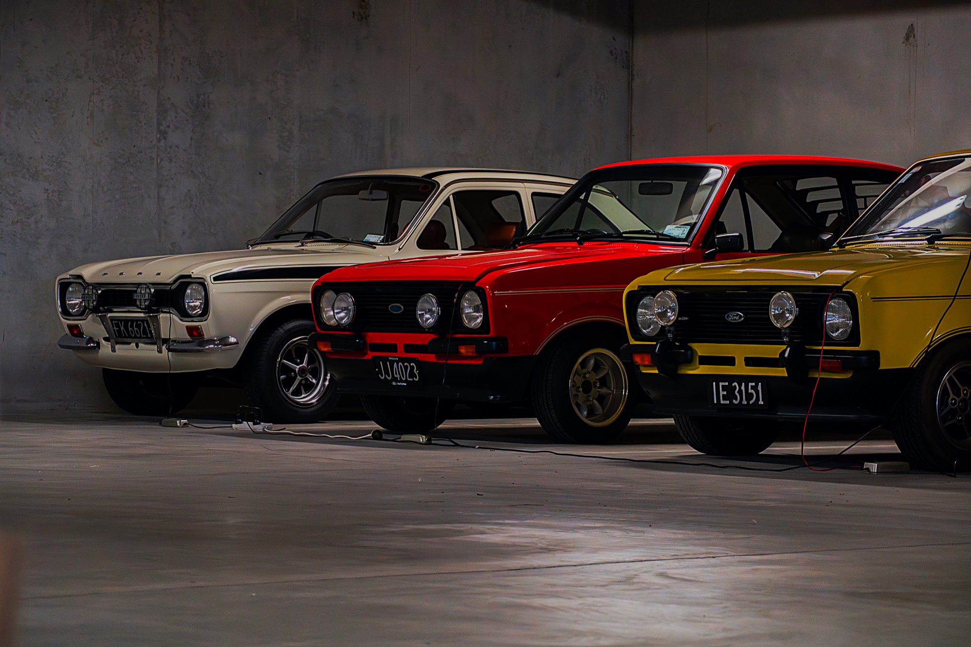 Classic cars on trickle chargers in the underground storage