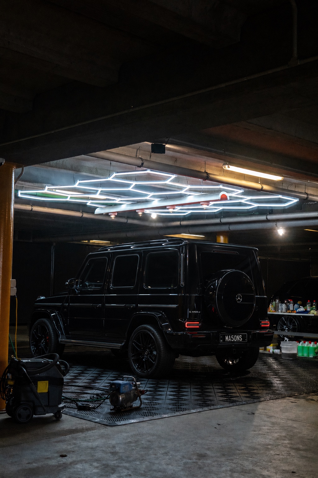 Black Mercedes-Benz G-Class under LED workshop lighting at Mason's Queenstown